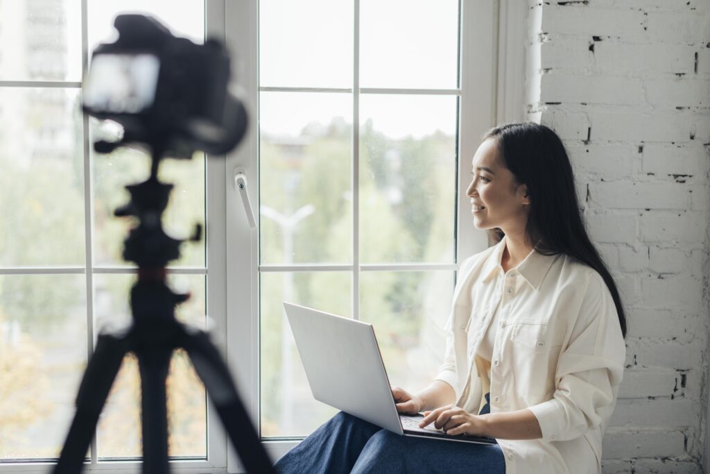 side view smiley woman doing vlog